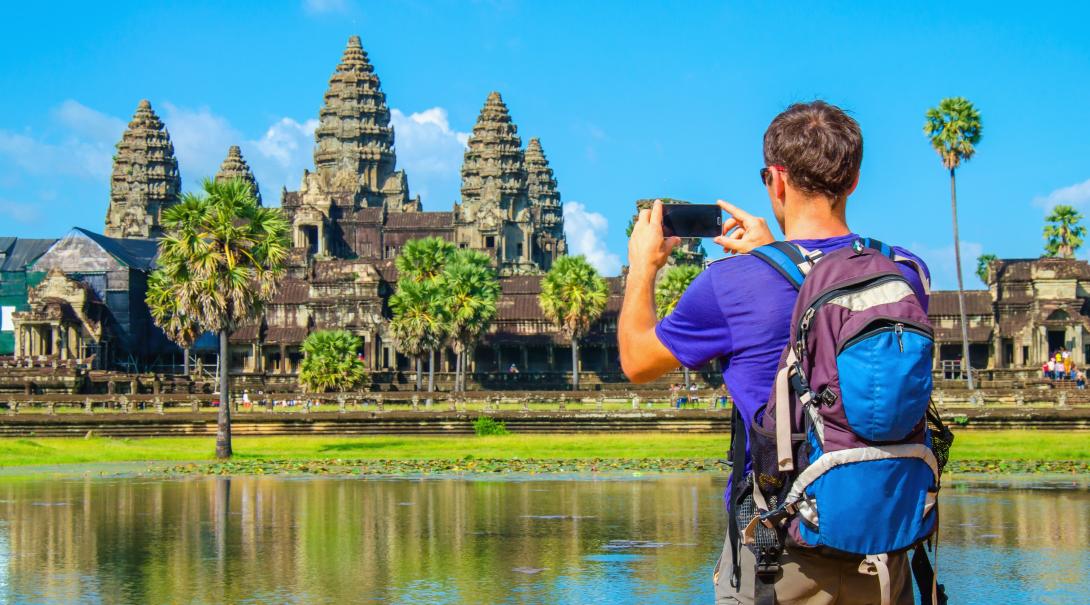Projects Abroad volunteer explores Cambodia during his free time. Traveller takes a photo of Angkor Wat during his travels through Cambodia.